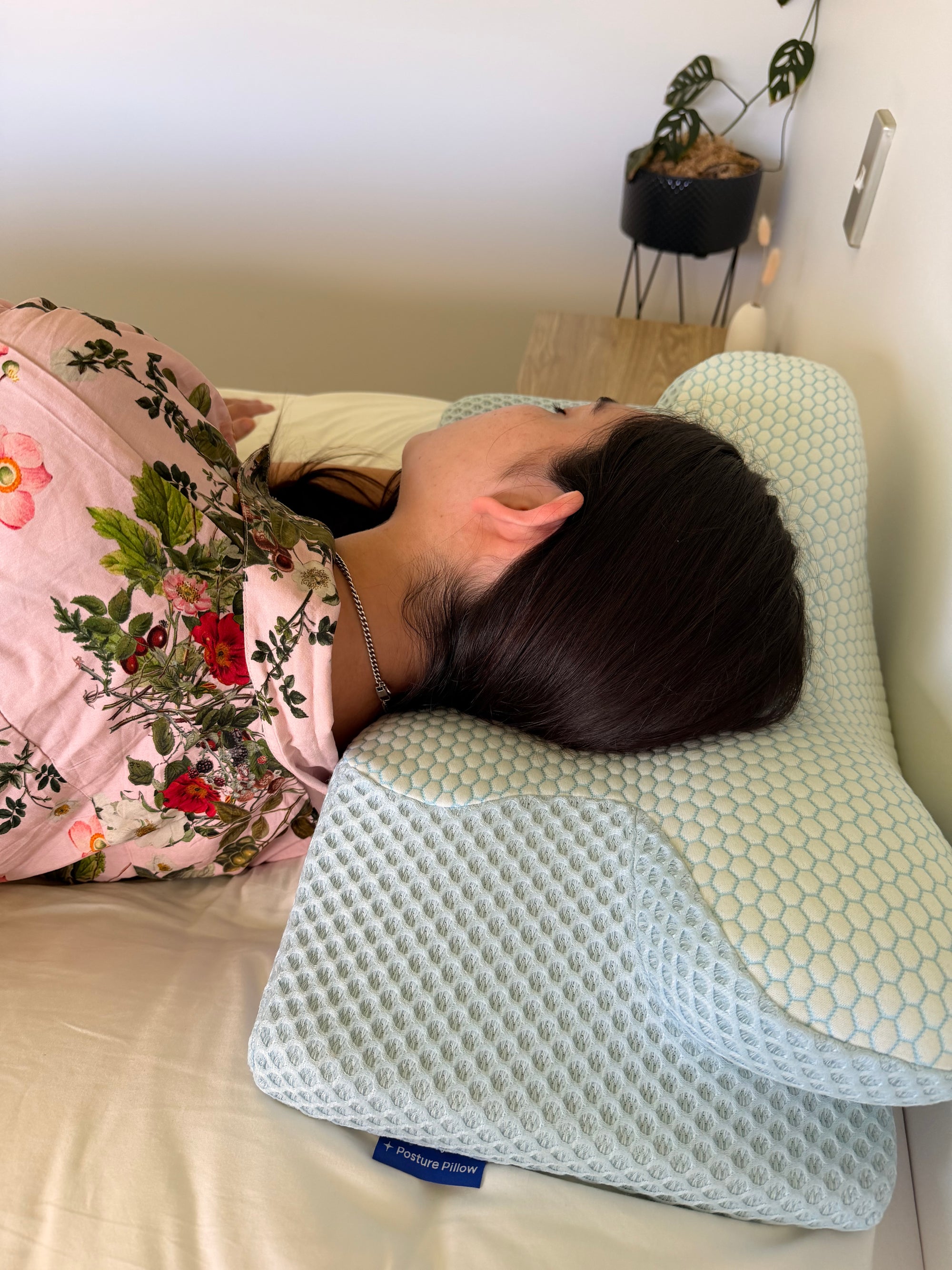 Women lying asleep on the orthopaedic NZ dream sleep posture pillow in alpine blue