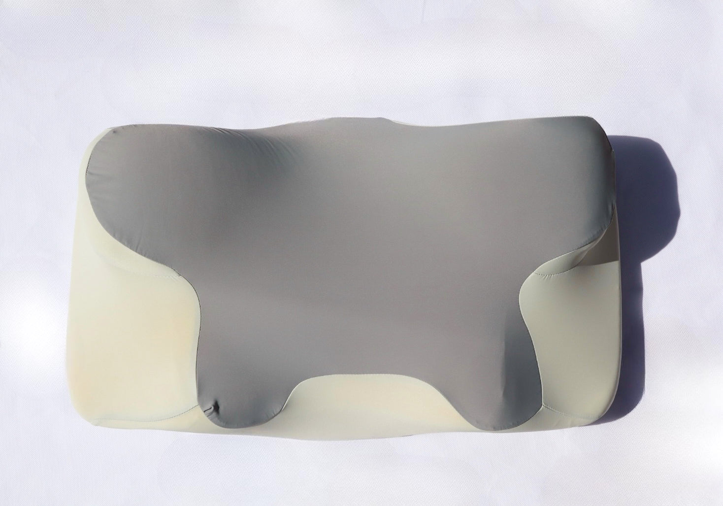 Gray and beige pillow on a white background