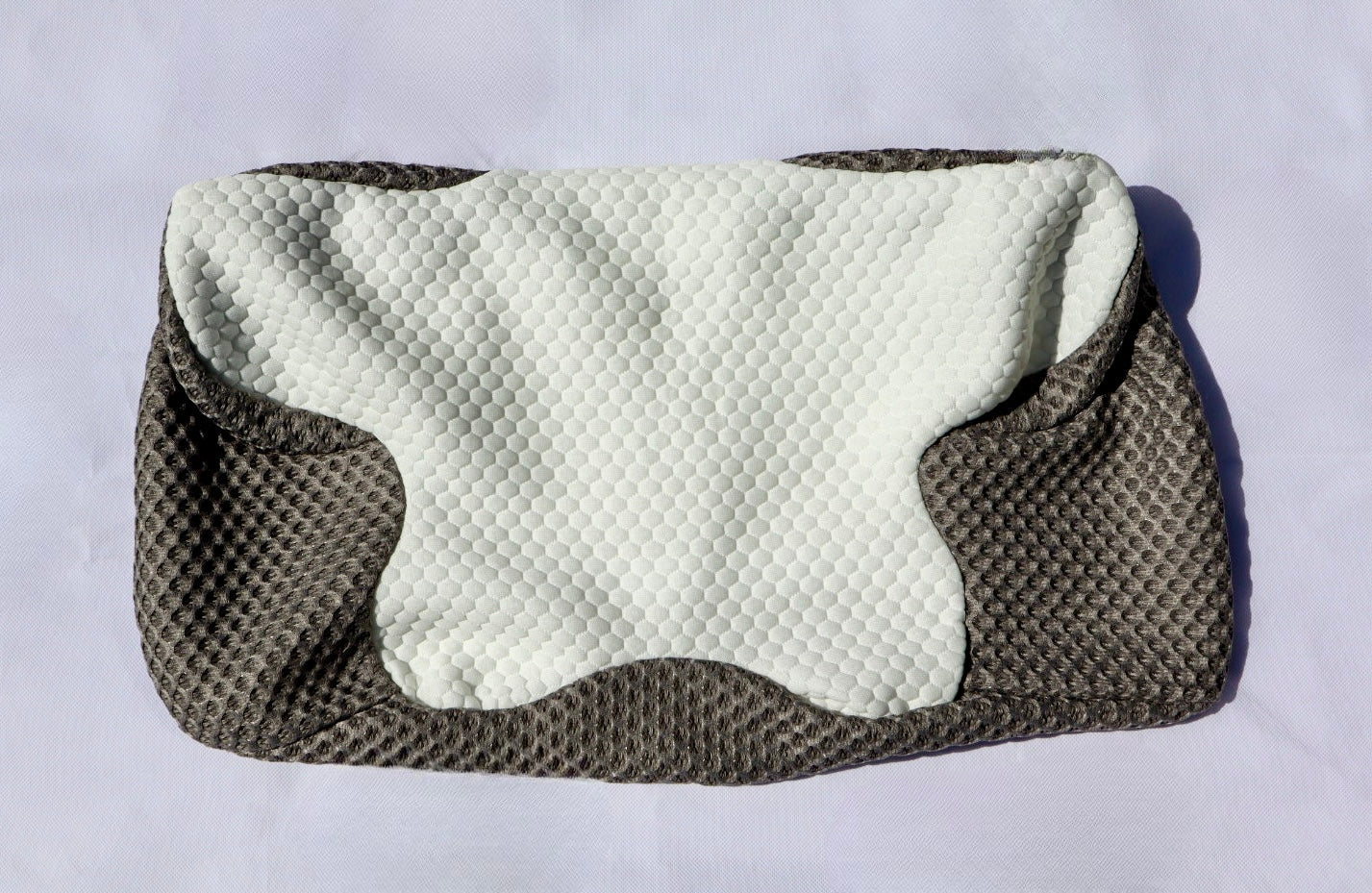 Neck pillow with textured surface on a light white background