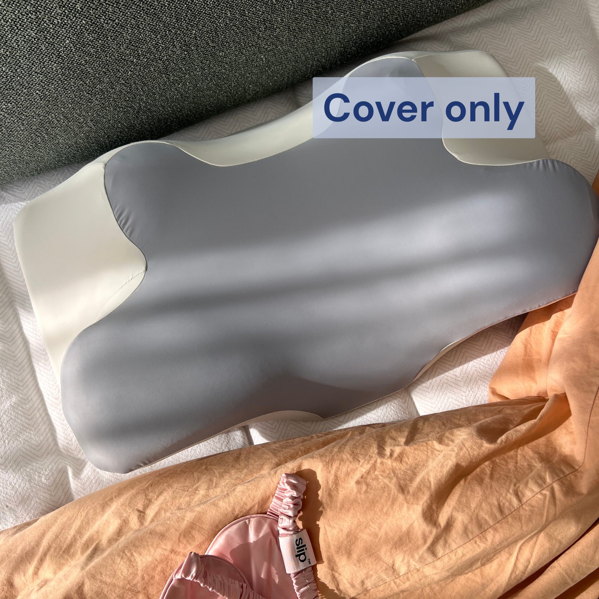 Close-up top view of a Dream Sleep NZ memory foam orthopaedic pillow featuring a soft Cloud Grey replacement cover on a bed.