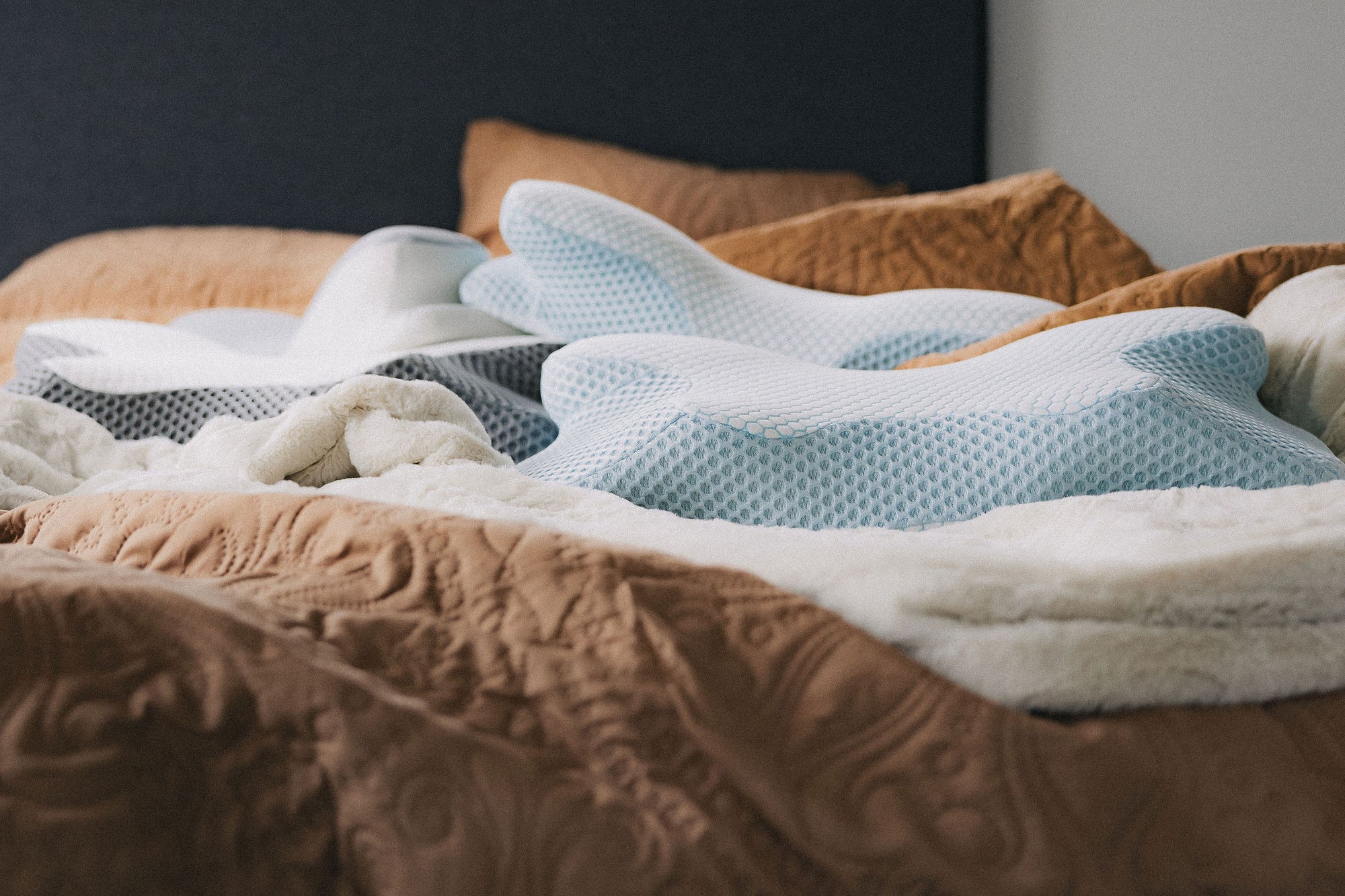 Dream Sleep Official premium memory foam ergonomic contour pillow on a bed, providing targeted head and neck support for perfect spine alignment and a deeper rest.