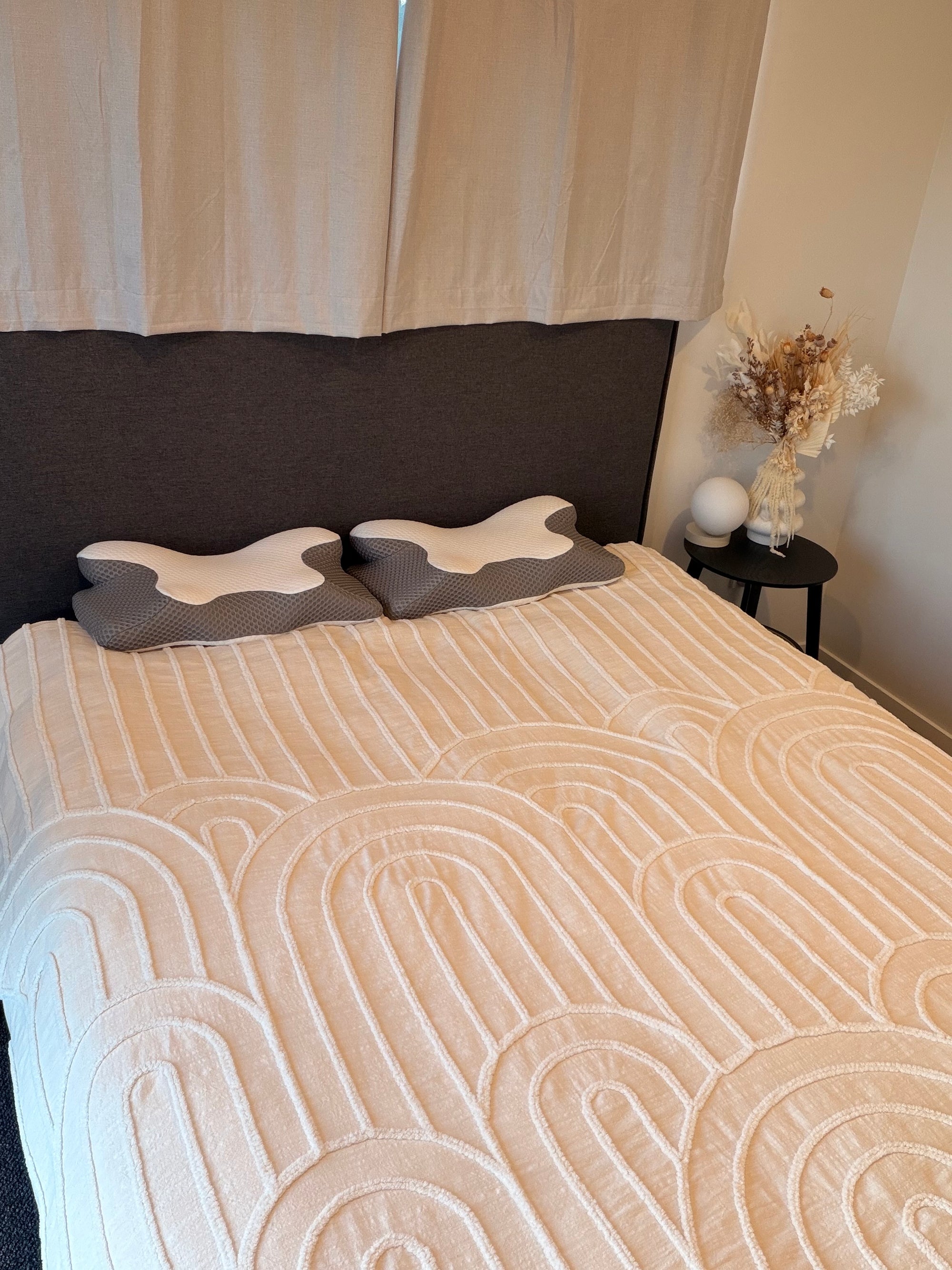 Lifestyle shot of the Signature Twin Pillow Set in Cloud Grey, showing two ergonomic contour memory foam pillows on a bed for a sophisticated, supportive sleep setup.